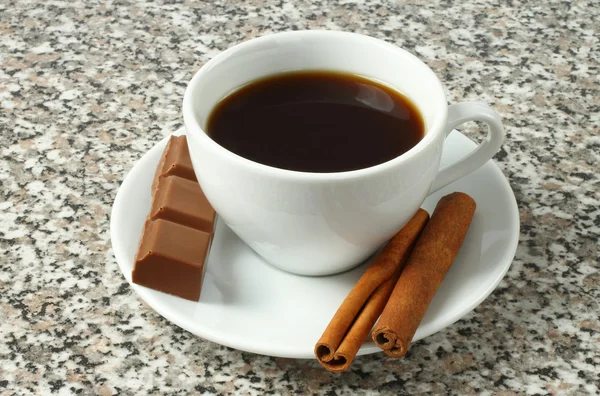 Cup of coffee with chocolate and cinnamon sticks — Stock Photo, Image