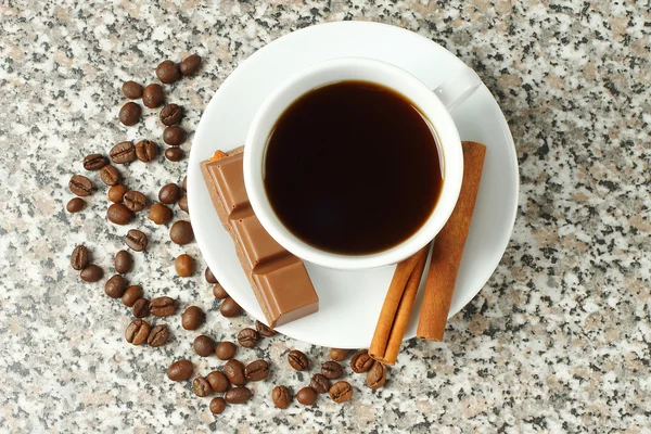 Cup of coffee with chocolate and cinnamon sticks — Stock Photo, Image