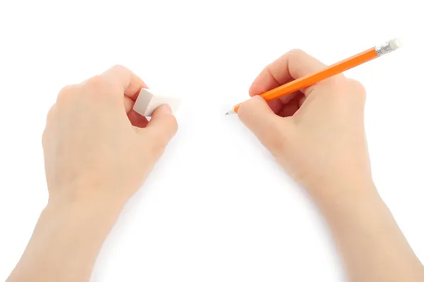 Vrouw handen met potlood en gum Stockfoto