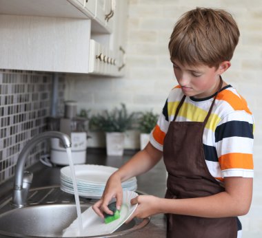 Boy doing the dishes clipart