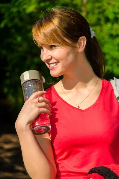 Portrait of female runner with bottle of water — Stock Photo, Image