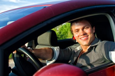 Portrait of a handsome man inside the car clipart