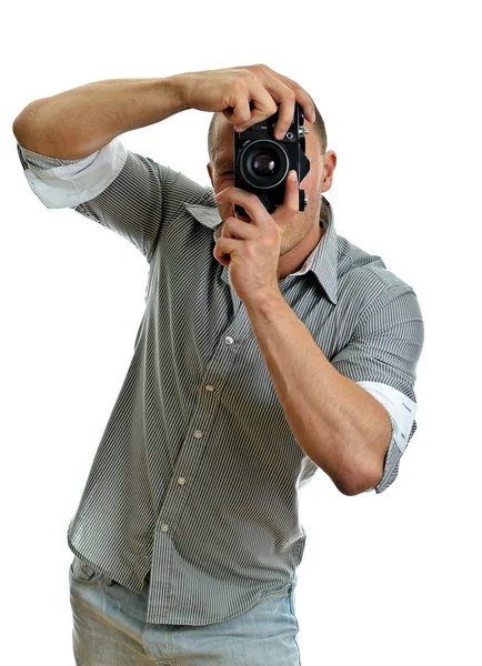 男は、レトロなカメラで写真を撮るします。白で隔離されます。. — ストック写真
