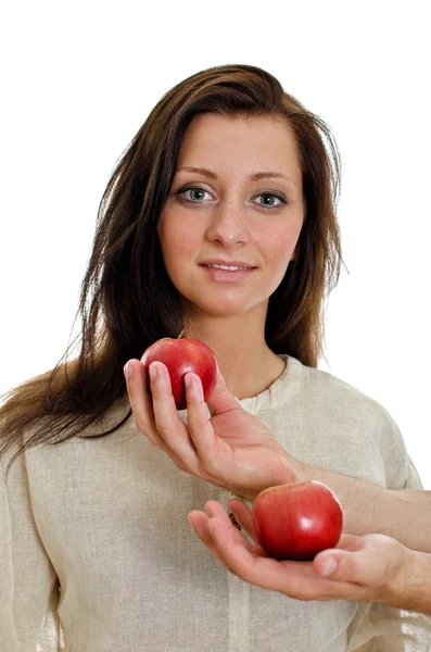 Two man's hand offering an apple to woman. Isolated on white. — Stock Photo, Image