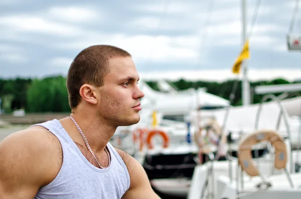 Portrait of attractive male against yachts. — Stock Photo, Image