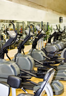 Athletic xtrainer machines in the fitness club clipart