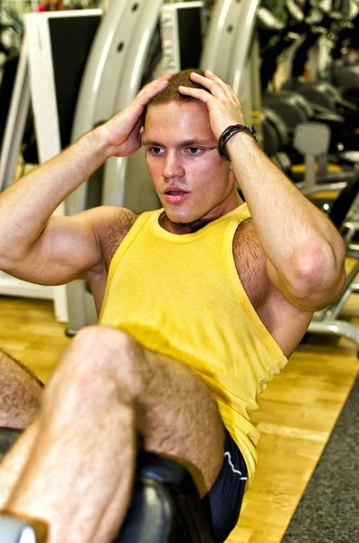stock image Portrait of handsome bodybuilder doing exercise in fitness club