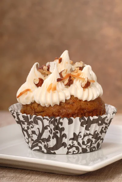 Delicious carrot cake cupcake with cream cheese frosting and nut — Stock Photo, Image