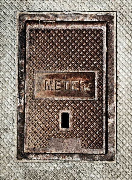 A meter lid in ground — Stock Photo, Image
