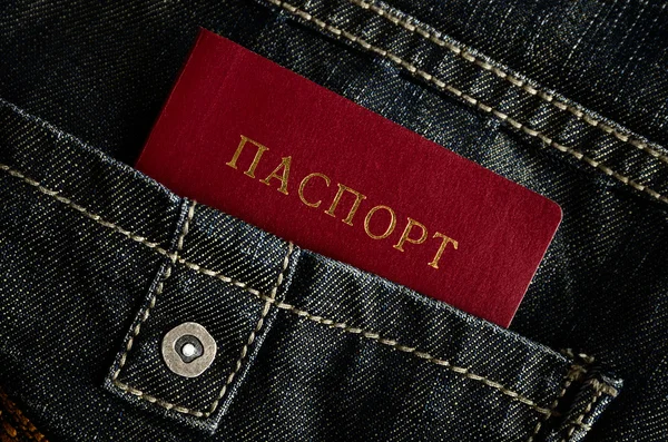 Красный паспорт и джинсы — стоковое фото