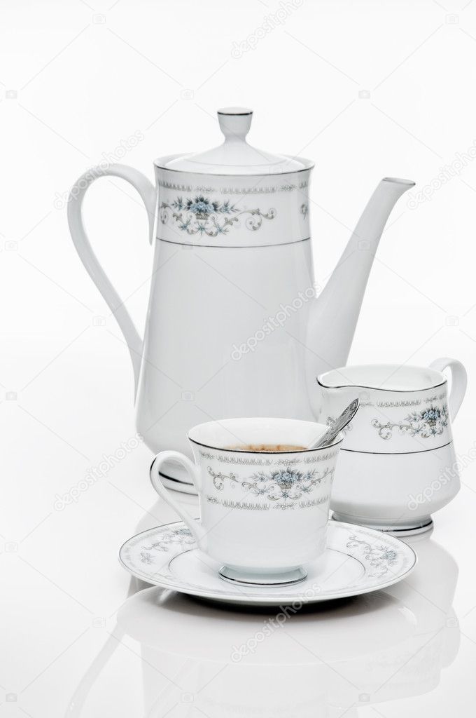 White cup and teapot