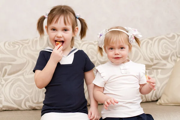 Two little girls with candies — Stock Photo, Image