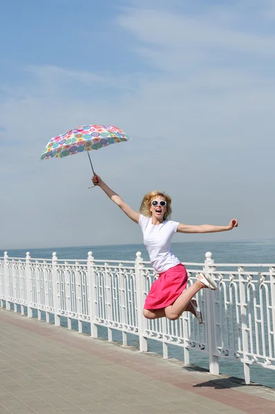Jump with umbrella — Stock Photo, Image