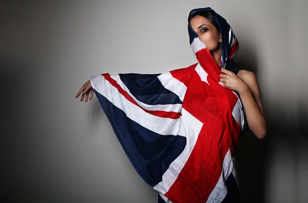 Beautiful young woman wearing British flag union jack flag — Stock Photo, Image