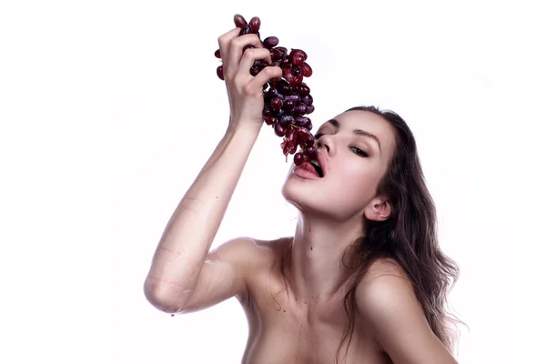 Stock image Beautiful young woman playing eating with grape