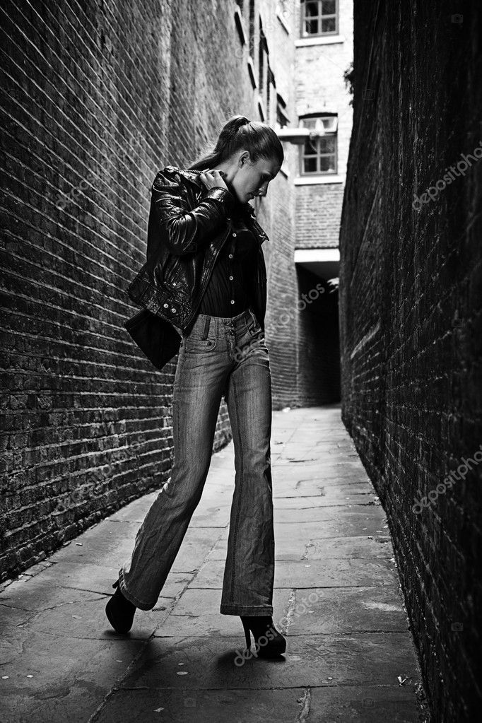 German blonde tall fashion model in a London Passing Alley posing ...