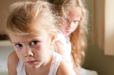 Two sad girls on the bed clipart