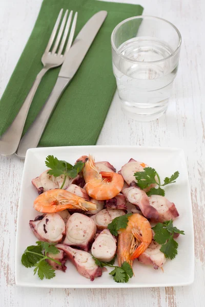 Салат из морепродуктов с петрушкой на белой тарелке — стоковое фото