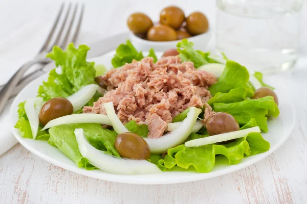Tuna salad with olives in white plate — Stockfoto