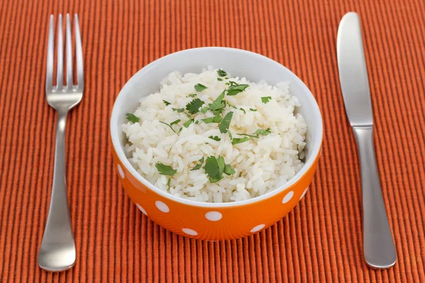 Stock image Boiled rice in orange bowl with parsley