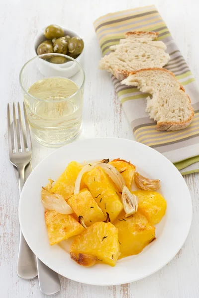 Potato on the white plate with olive, bread and white wine — Stock Photo, Image