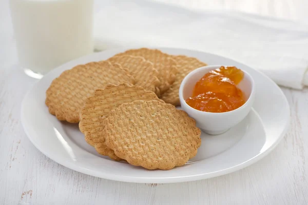 Печенье с абрикосовым джемом на белой тарелке — стоковое фото