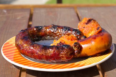 Grilled sausages on the plate clipart