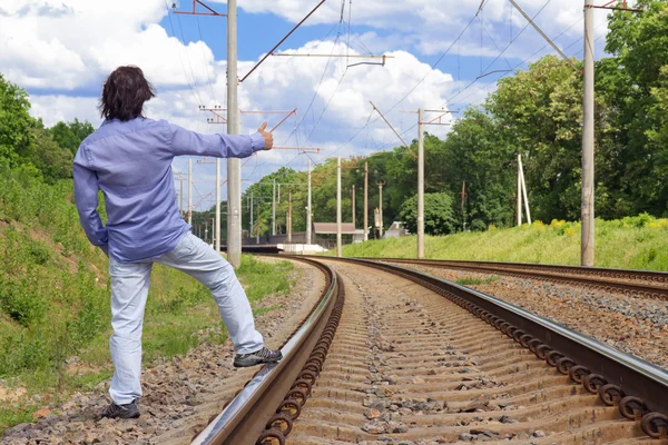 Man hitch-hiking on a train tracks — Stock Photo, Image