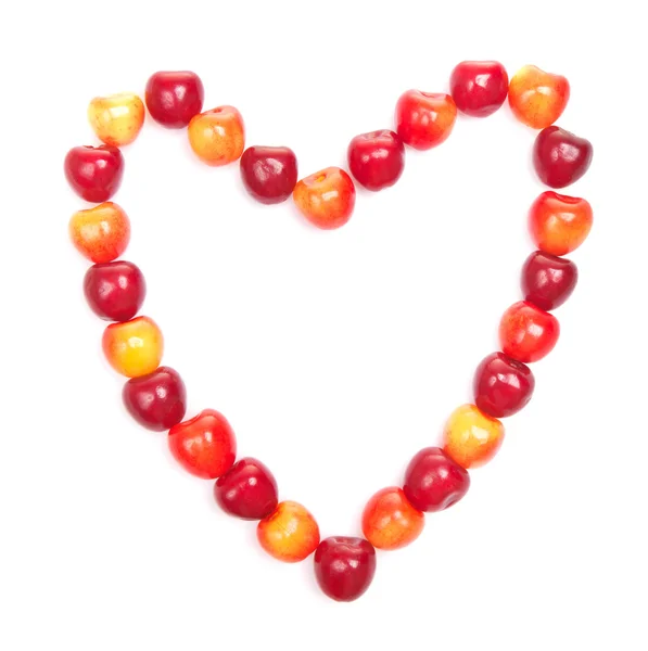 Červené a žluté třešně ve tvaru srdce — Stock fotografie