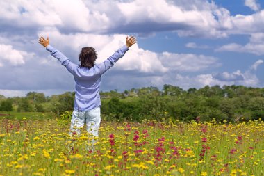 Man with arms wide open in the middle of the field clipart