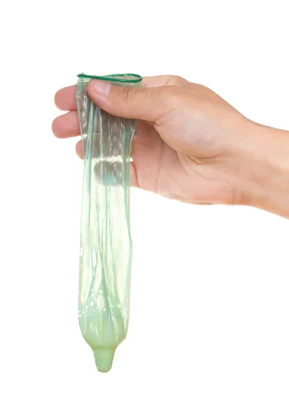 녹색 가득 절연 손에 콘돔 — 스톡 사진