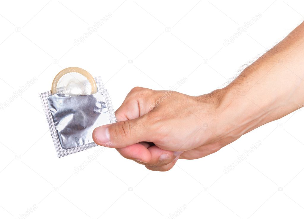 Hand with condom isolated on white