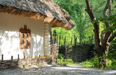 Old clay house with straw roof clipart