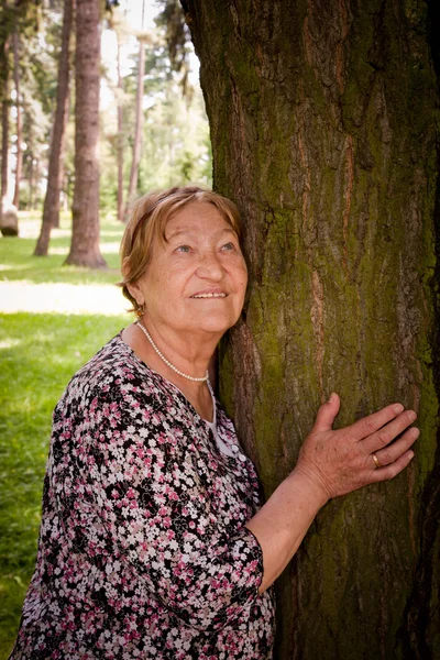 Happy senior woman in forest — Stock Photo, Image