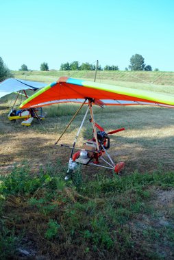 Colorful hang gliders ready for the take off clipart