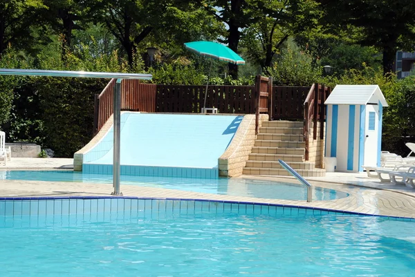 Limpid swimming pool and a waterslide without