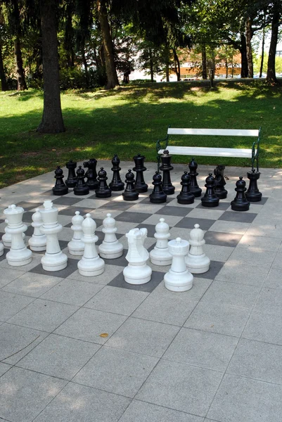 Stock image Big chess set in the park with benches