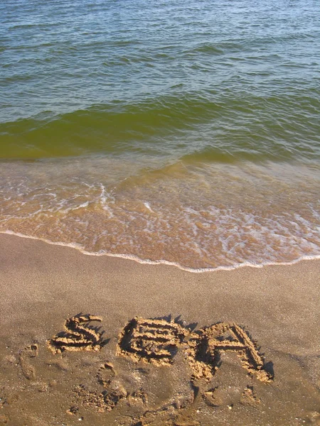 Deniz kum üzerinde yazıt — Stok fotoğraf