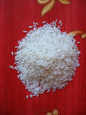 Scattered rice on a red background clipart