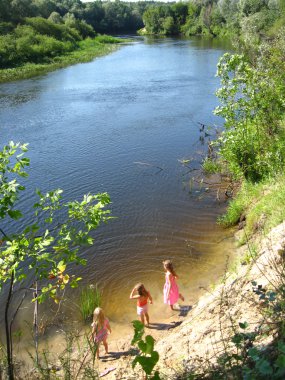Three little girls plays at the river clipart