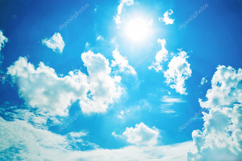 White clouds in sunny blue sky.