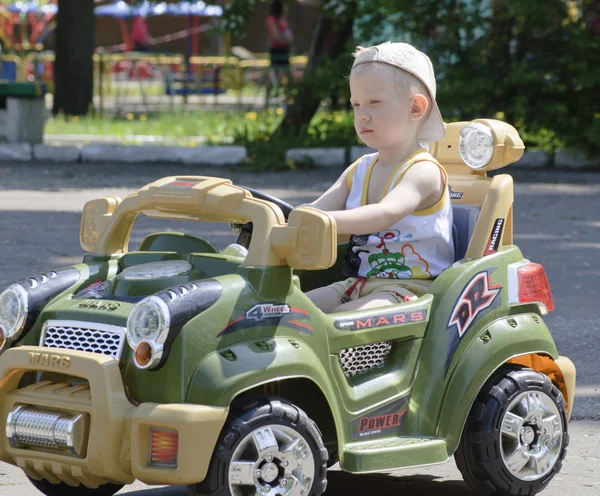 Stock image Small boy in baby car