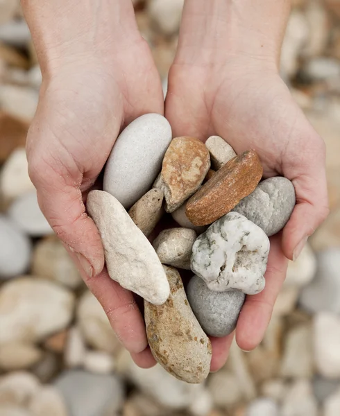 stock image Hands holding pebbles