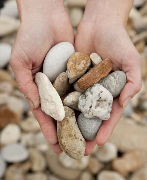 stock image Hands holding pebbles