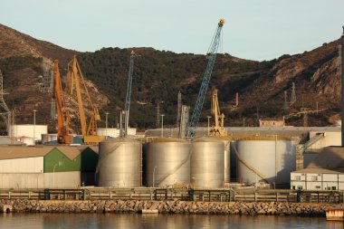 Fuel storage tanks at the industrial port clipart