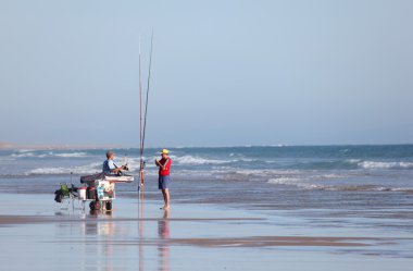 Fishermen on the beach of Conil de la Frontera, Andalusia Spain clipart