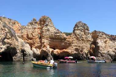 Boats at the Ponta de Piedade in Lagos, Algarve coast in Portugal clipart