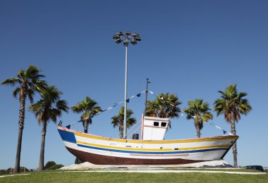 Old fishing boat in the roundabout of Matalascanas, Andalusia Spain clipart