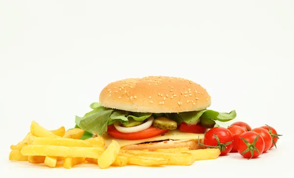 Fresh cheeseburger with fries, salad and tomatoes — Stock Photo, Image