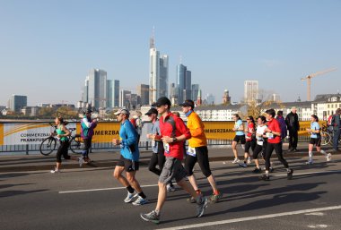 Runners on the bridge over the Main River during the Frankfurt Marathon 2010 in Germany clipart